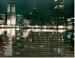 cx-21497-001.jpg	Night picture of a lit up city from across the water. Caption reads, " security resolution" 


